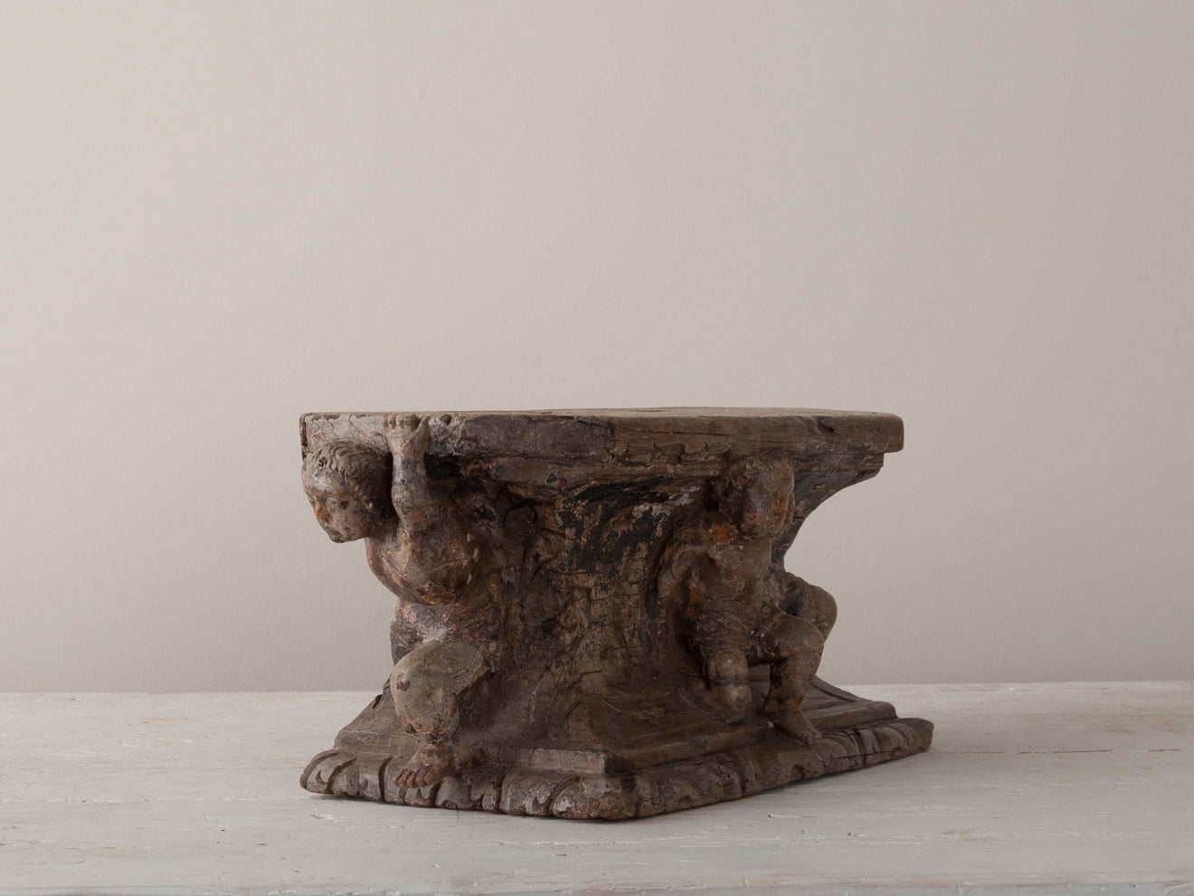 PEDESTAL WITH CARVED PUTTI